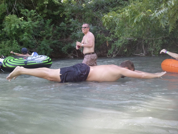 That man is not sliding down the river.