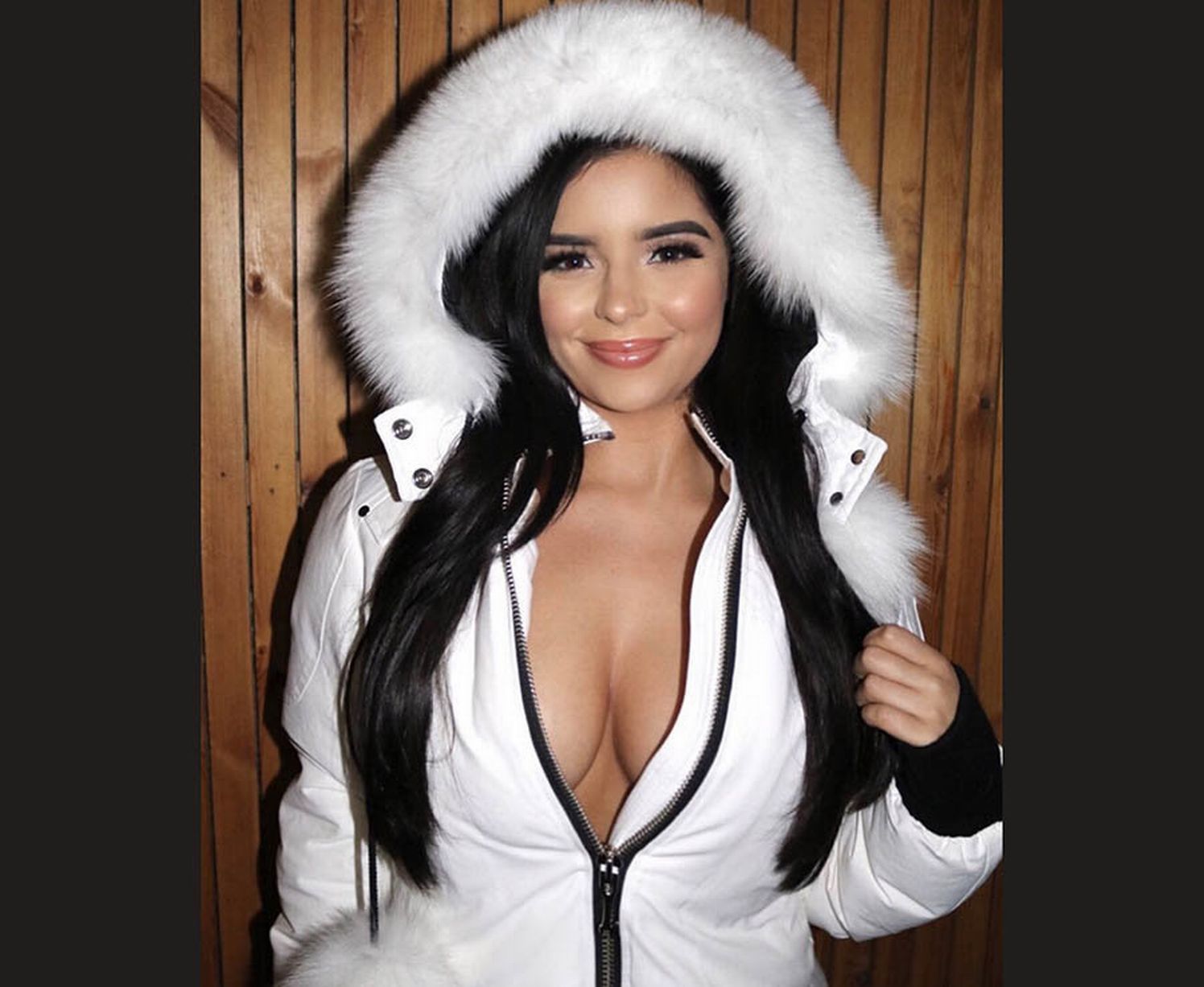 Demi Rose unzips jacket in braless display