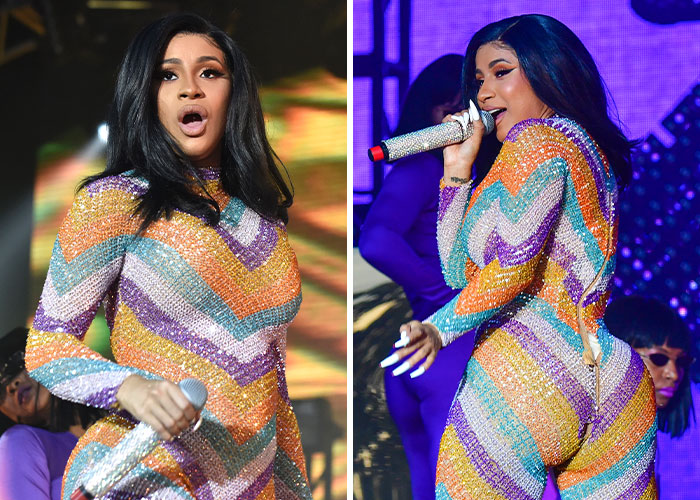Female celebrity on stage wearing a colorful glittery outfit with a visible wardrobe malfunction during a live performance. Female celebrity on stage wearing a colorful glittery outfit with a visible wardrobe malfunction during a live performance.