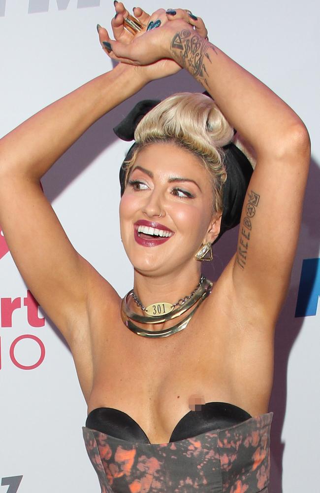 British singer and songwriter Neon Hitch suffers a major nip slip while dancing on red carpet at the 2013 KIIS FM’s Jingle Ball in Los Angeles, CA on December 6, 2013. Picture: Splash News