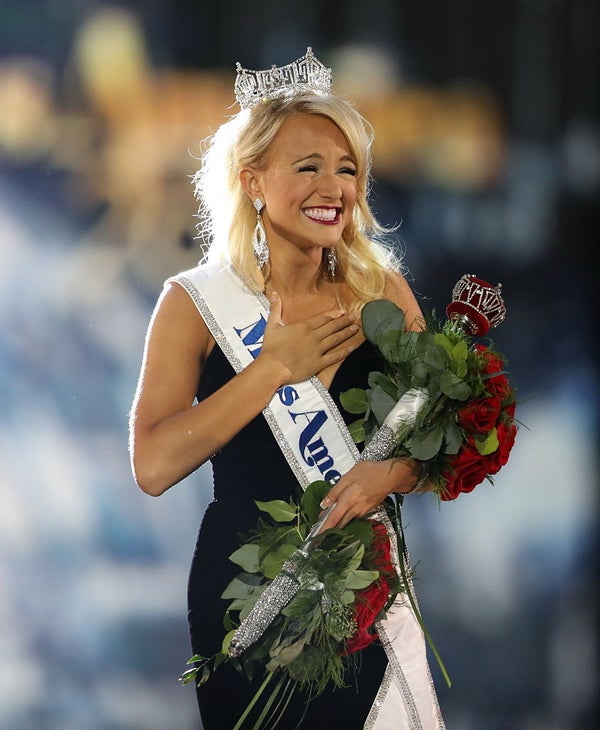 Shields smiling and holding roses