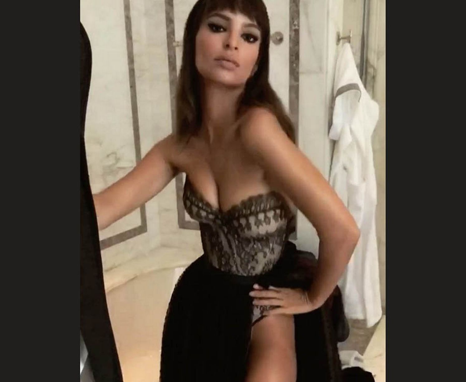 Emily Ratajkowski whips back skirt for raunchy lingerie flash